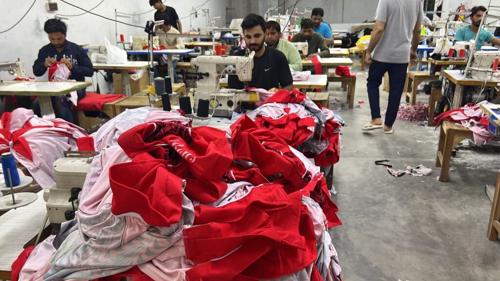 Scarlett Solo Wear factory production floor with sewing machines and sportswear manufacturing in progress